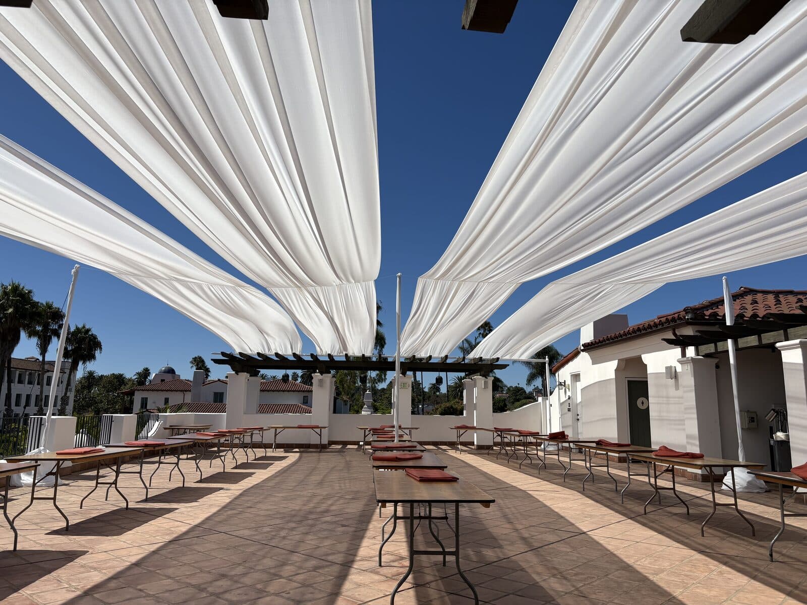 Billowing white fabric draping installed over a Santa Barbara rooftop terrace